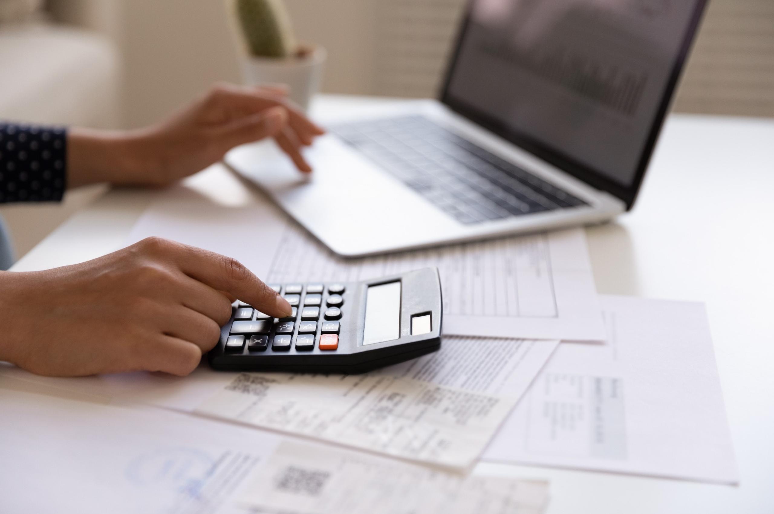 Woman using a laptop and calculator